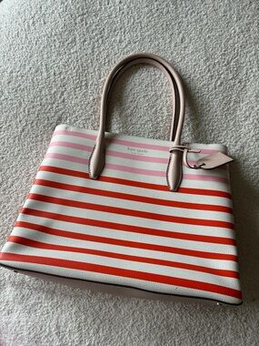 Like new Kate Spade bag. Red, pink & white striped.